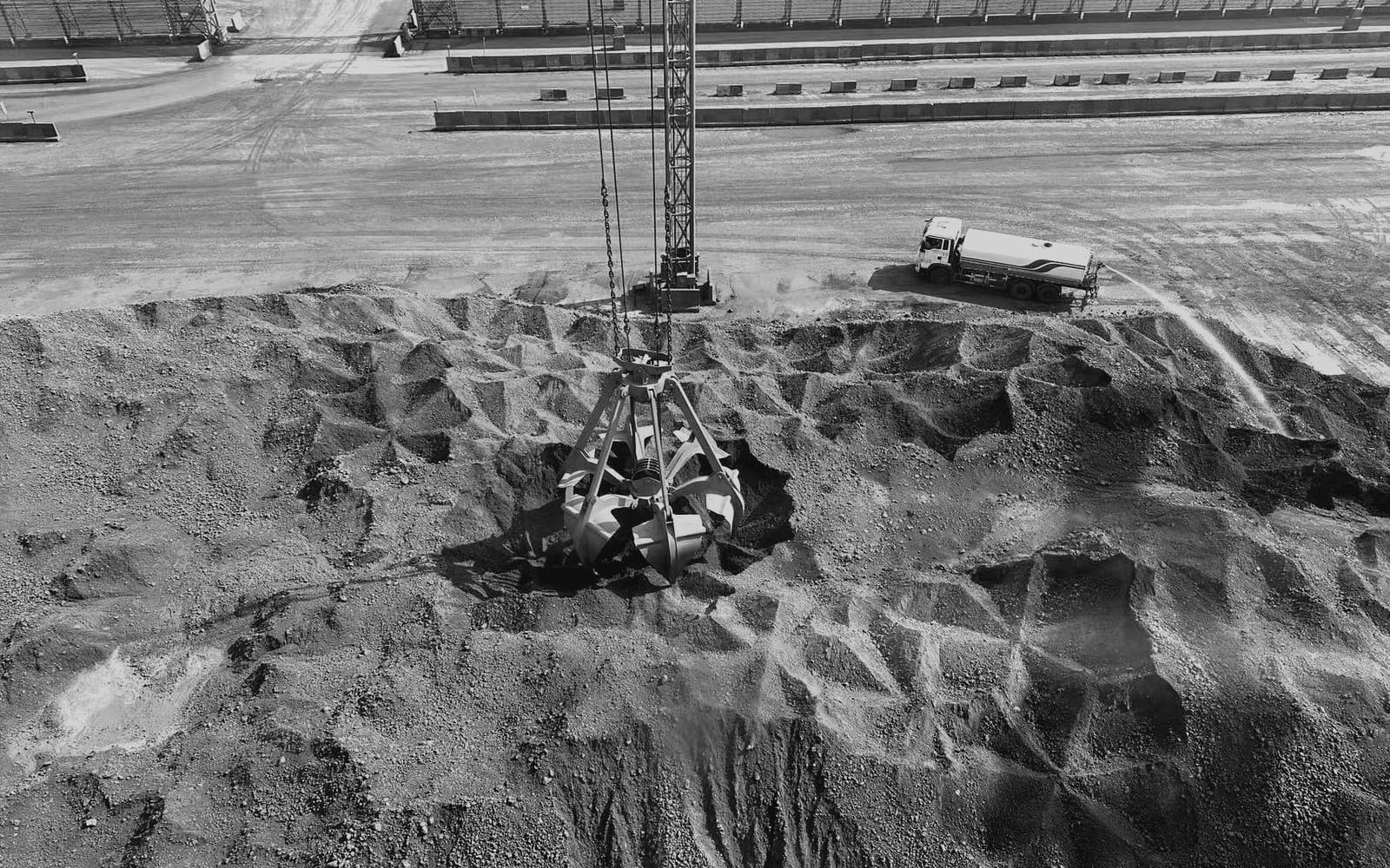 A portal crane’s grab working on a stockpile.