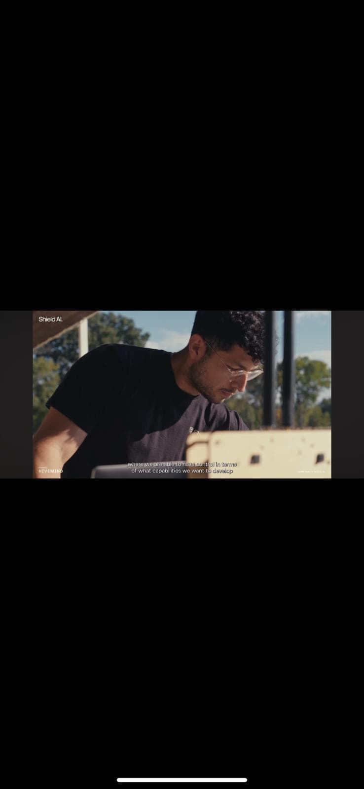 Working at a laptop in the field, in a still from the RSAF program film.