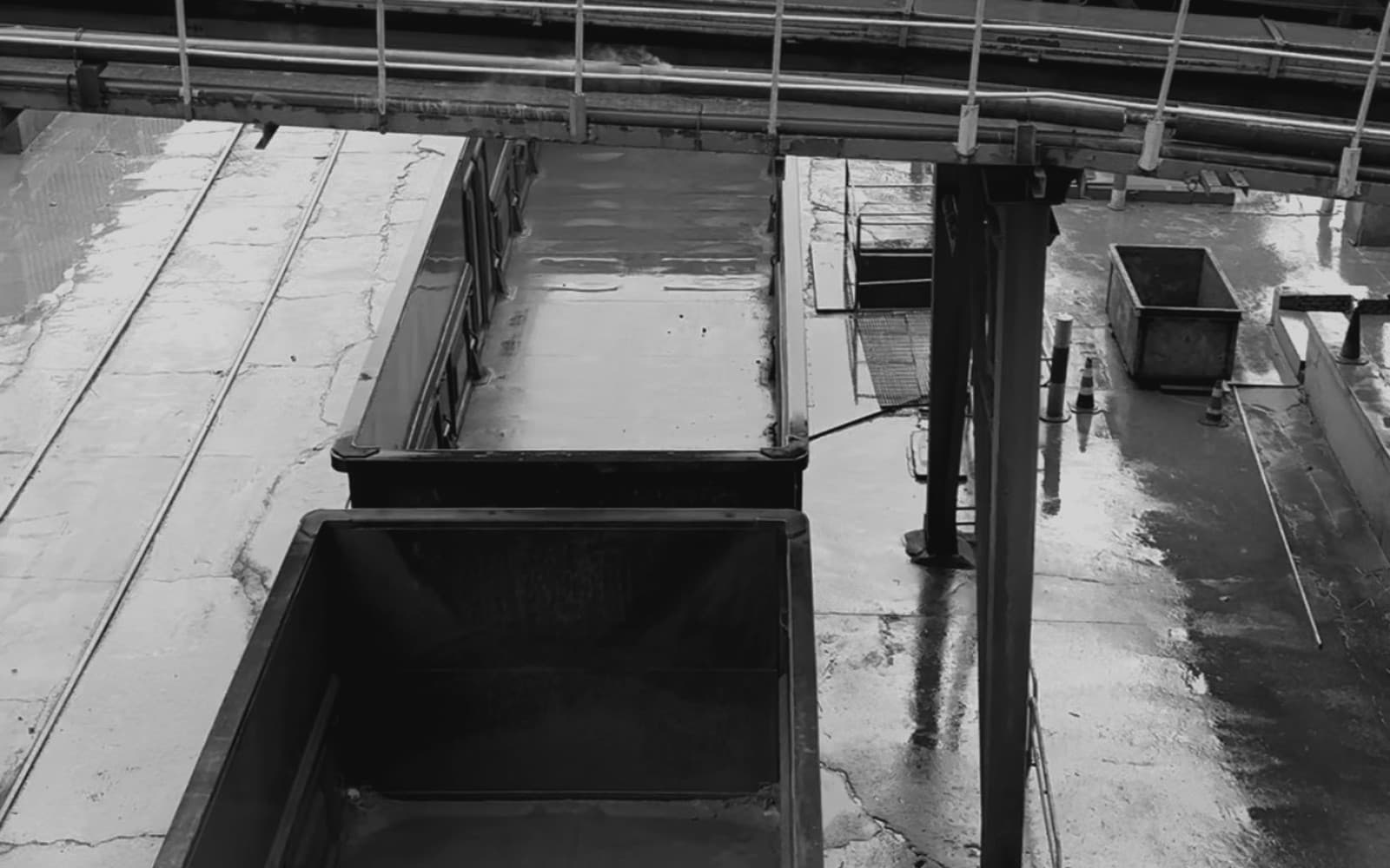 Open-top train cars beneath a loading chute.